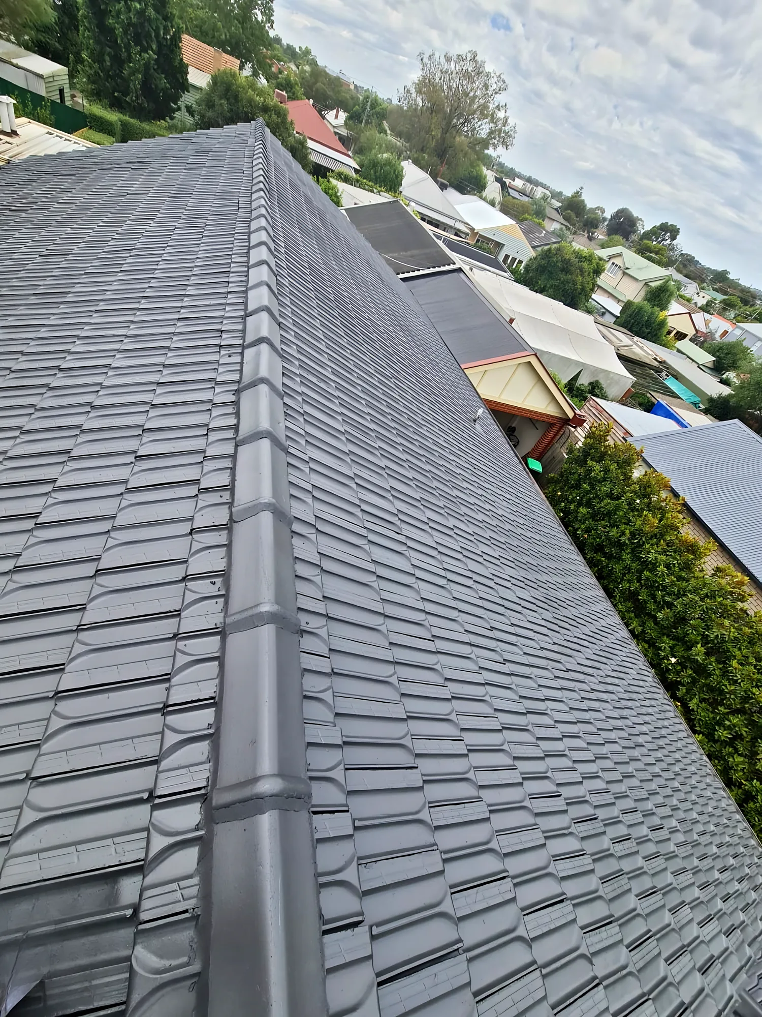 Concrete tile roof with a fresh charcoal coating and repointed ridge capping